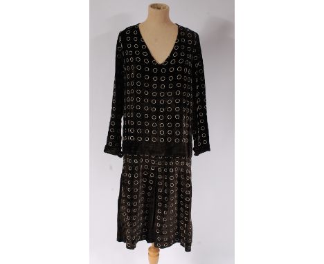 A 1920s black silk velvet lightweight dress, with embroidered circle decoration, pleats to hem; together with a 1950s black v
