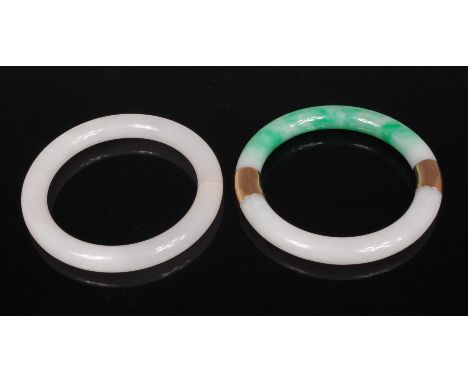 A Chinese white jade bangle, 8.1cm (hairline); together with a Chinese green and white jade bangle, with yellow gold mounts (
