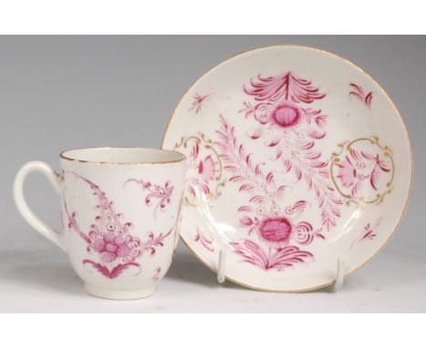 A late 18th century Worcester porcelain coffee can and saucer, decorated in puce enamels with leaves and sprays of flowers in