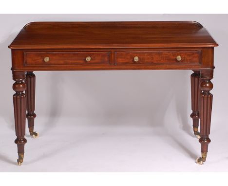 A Victorian mahogany two drawer side table, in the manner of Gillows, on knopped, turned, tapering and reeded supports with b