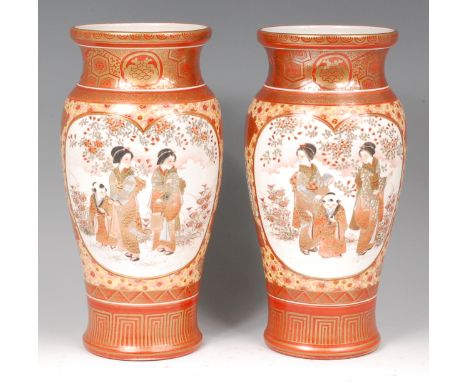 A pair of Japanese Meiji period kutani vases, each decorated with opposing reserves of figures scenes and birds amidst blosso