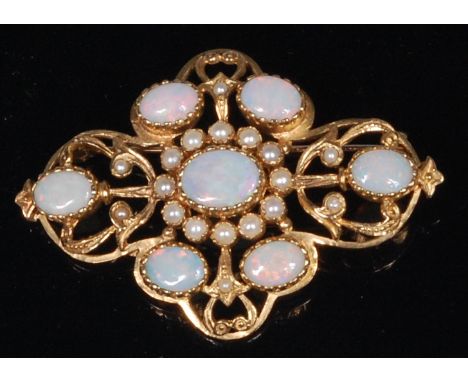 A Victorian style 9ct gold, opal and seed pearl set openwork brooch, arranged as seven cabochon opals, the centre with a surr