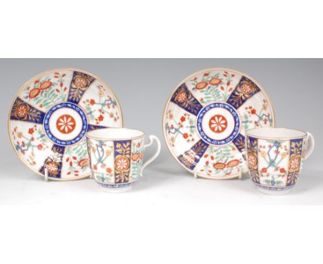 A pair of first period Worcester coffee cups and saucers, decorated in the Kakiemon style, Queens pattern, underglaze blue cr
