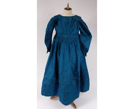 A mid-19th century childs / small ladies blue silk taffeta dress, with puffed sleeves, pleated bust and high neck; together w