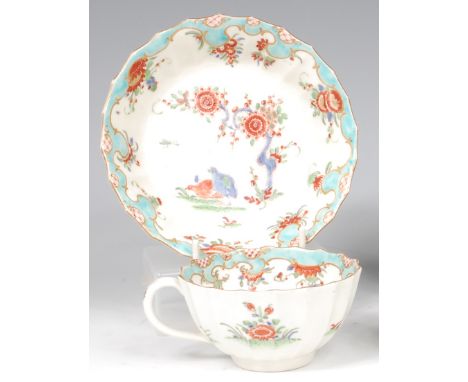 A first period Worcester teacup and saucer, each of fluted circular form, painted in the Two Quail pattern in the Kakiemon st
