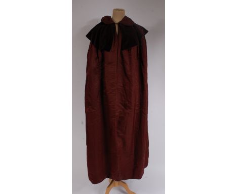 A Victorian shot silk fully lined full length cape, having velvet collar; together with one other black silk lined cape with 