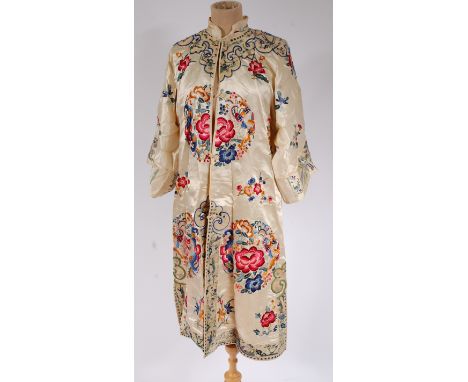 A late 19th century Chinese silk gown, finely worked with reserves of figures, flowers and foliage  Condition Report / Extra 