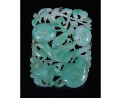 A Chinese celadon and green jade brooch, in yellow metal mount, carved as a bird amidst fruit, flowers and foliage, 4.5x3.4cm