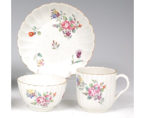 A first period Worcester trio, comprising tea bowl, saucer and coffee can, each of fluted form, polychrome decorated with spr