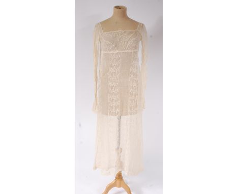 A Regency period embroidered muslin dress, with gathered back; together with another 19th century embroidered muslin dress (2