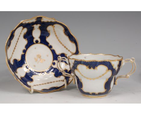 A Worcester porcelain twin handled chocolate cup and saucer, the cup having pierced twin handles, both pieces decorated with 