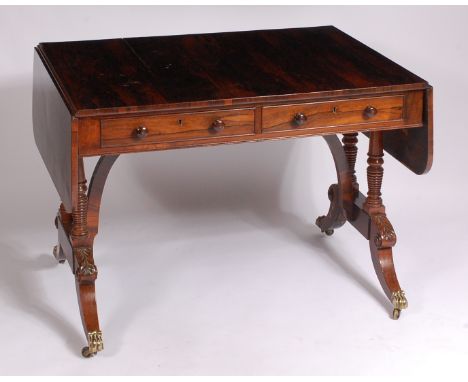 A Regency rosewood sofa table, having twin frieze drawers and raised on double ring turned end supports with square cut arche