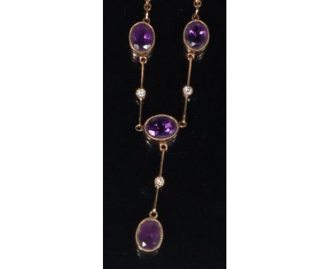An Edwardian 9ct gold, amethyst and diamond set necklace, arranged as four oval cut amethysts on knife-edge links, each centr