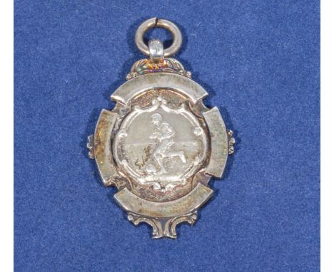 Football interest, a silver fob watch medallion depicting a footballer in play, silver mark for Chester 1951 makers mark TJS 