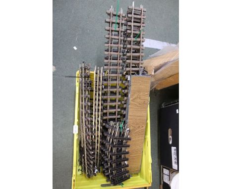 A selection of large scale model train track, together with a flatbed wagon