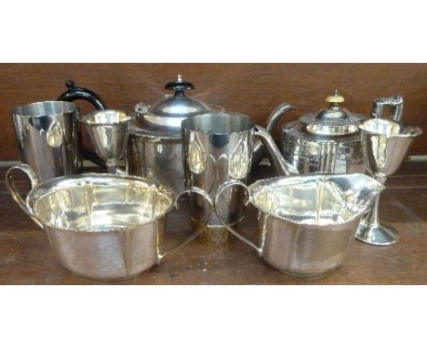 A three piece plated tea set, a plated teapot, two goblets and two Viners beakers