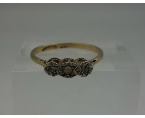 A yellow metal ring set with three old cut diamonds, weight 1.6g, size M