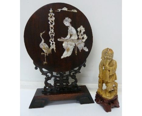 A mahogany and mother of pearl inlaid table top screen and a carved soapstone figure of an oriental fisherman, height of scre