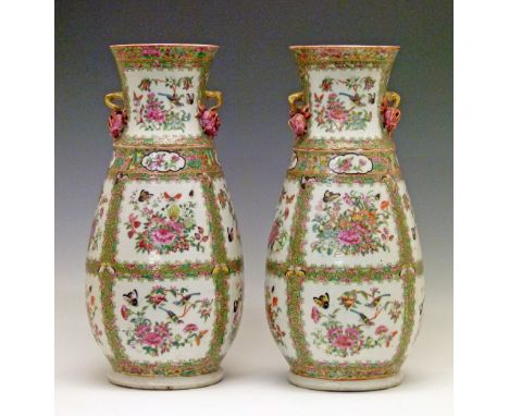 Pair of Cantonese ovoid shaped vases, each with multiple reserves decorated with butterflies amongst foliage on a tight-knit 