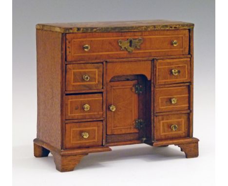 19th Century inlaid walnut and oak miniature model of a kneehole desk fitted seven drawers with a cupboard to the kneehole an