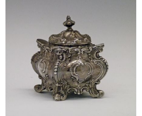 Victorian silver square shaped tea caddy having embossed scroll decoration and standing on scroll feet, makers Walker & Hall,