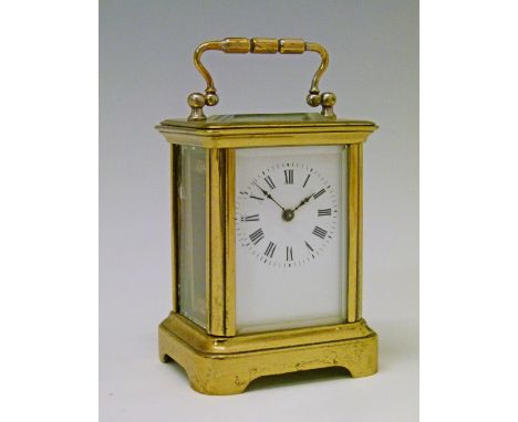 Small early 20th Century French brass cased carriage clock, the white enamel dial with Roman numerals, 7cm high with handle d