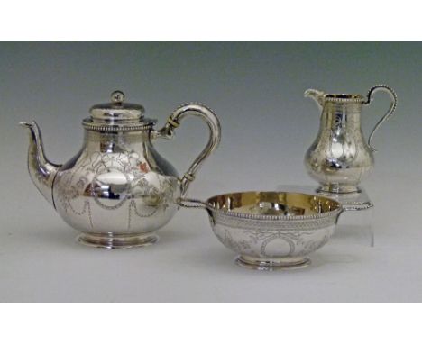 Victorian engraved silver three piece tea set having foliate ribbon and swag decoration and comprising: squat baluster shaped