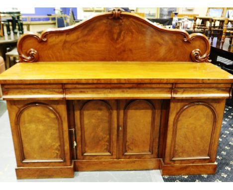 A 19th century flame mahogany buffet, having three drawers above four locking cupboards and carved upstand, 168 x 53 x 130 cm