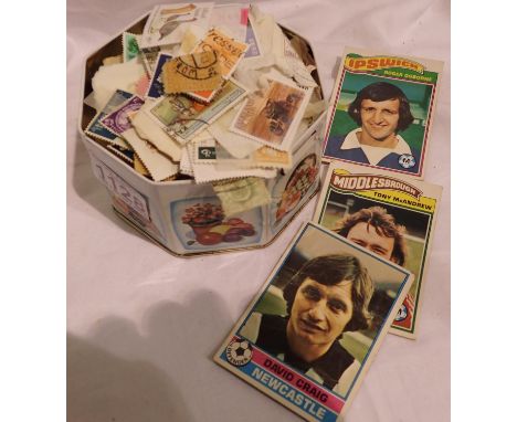 Tin of used world stamps and three football cards. P&amp;P Group 1 (£14+VAT for the first lot and £1+VAT for subsequent lots)