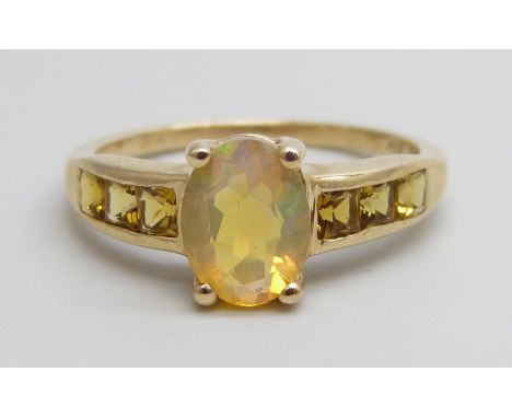 A 9ct gold ring set with an Ethiopian opal and yellow stones, 2.3g, N/O