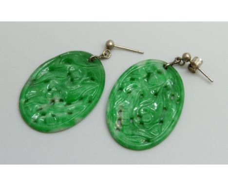 A pair of jade earrings, 21mm x 30mm, (with one fastener marked 750)