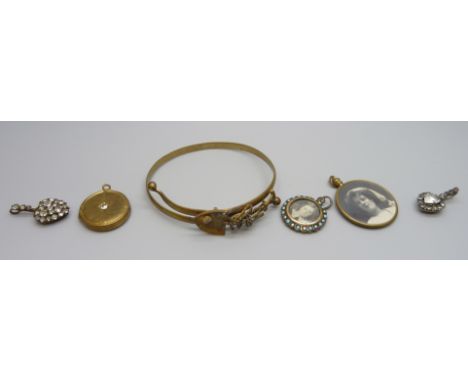 A collection of Victorian jewellery; two pendants, two photograph pendants, a locket and a mining bangle marked South Africa