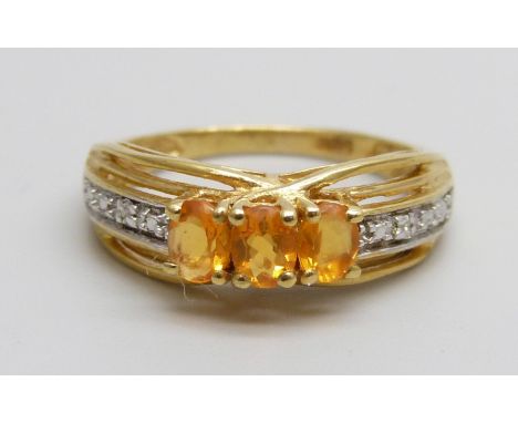 A silver gilt fire opal and diamond accents ring, K