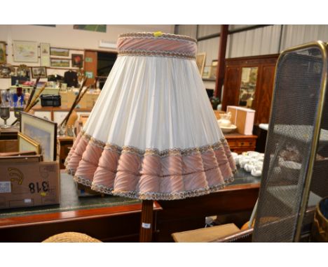 A mahogany standard lamp and shade