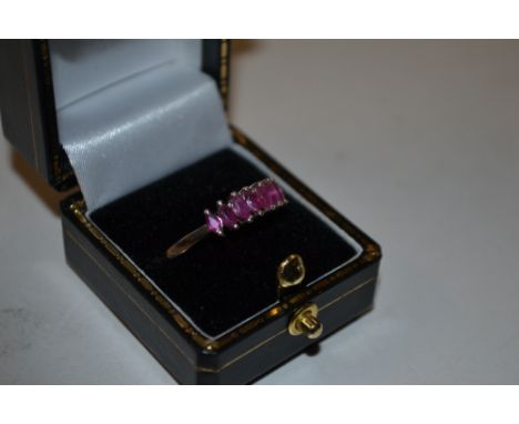 A silver and ruby stone set dress ring