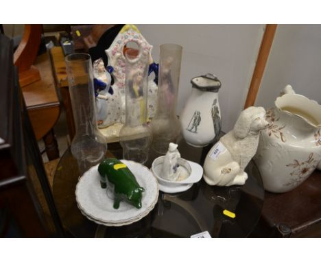 Three oil lamp chimneys; together with a 19th Century Staffordshire figural clock case; a Staffordshire dog etc. 