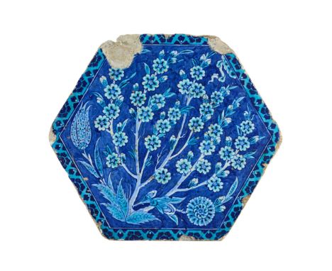 AN EXTREMELY RARE IZNIK POTTERY TILE FROM THE CINILI HAMAM OTTOMAN TURKEY, CIRCA 1540 of hexagonal form, underglaze, the main