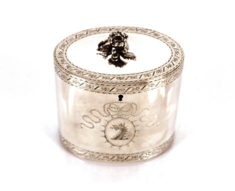 A George III silver tea caddy, by George Smith, of oval form the hinged lid surmounted by a foliate finial, the body with sty