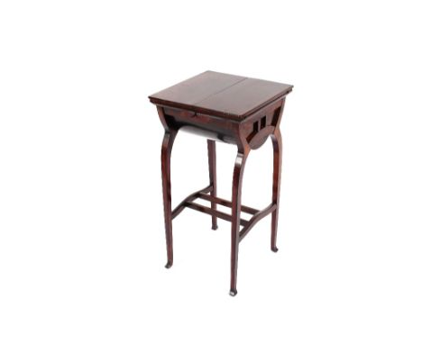 An Art Deco design mahogany sewing table with hinged top, raised on bowed supports united by under tier, 37cm wide&nbsp;