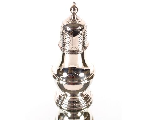A late 1970's silver sugar shaker of baluster form, surmounted by a knop finial and raised spread foot, London 1978, 18cm hig