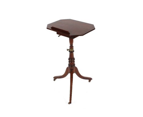 A Georgian mahogany tripod reading table, the octagonal adjustable top raised on a turned baluster column and triple splay