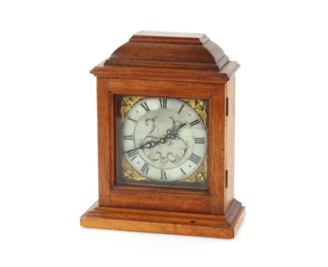 A mahogany cased mantel clock, having ornate brass and steel dial, 27cm high (having battery replacement movement)