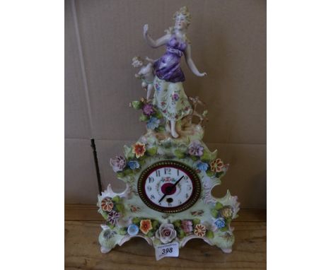 An early 20th Century Continental mantel clock in elaborate porcelain floral encrusted case