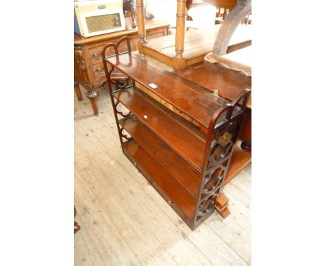 A modern mahogany wall mounted shelf with two base drawers and fretwood ends