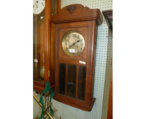 An early 20th Century oak cased wall clock