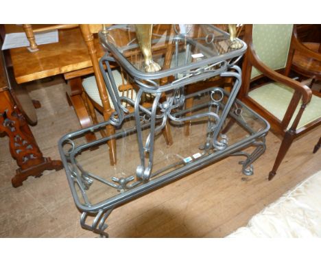 A modern metal framed coffee table with glass top together with a similar lamp table.