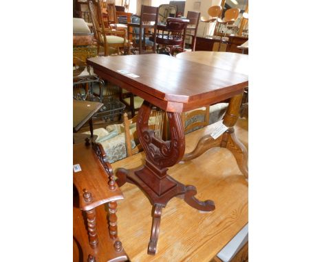 A reproduction carved hardwood lamp table raised on lyre form supports.