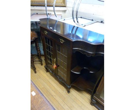 An Edwardian Chippendale revival parlour cabinet, having single frieze drawer with blind fret decoration and two leaded glaze