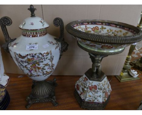 A modern metal mounted and ceramic pedestal bowl with cherub support together with a similar double handled covered urn (2)