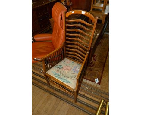 An Edwardian mahogany ladderback armchair with floral tapestry seat 